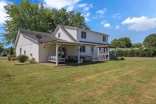 rear view of house with a patio area and a lawn