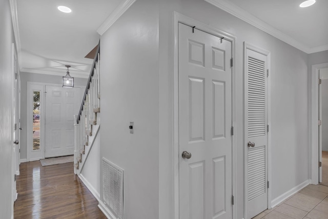 hallway featuring light tile patterned flooring and crown molding