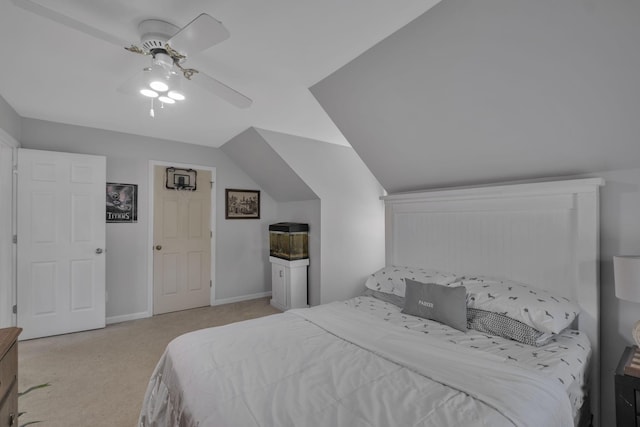 carpeted bedroom with ceiling fan and vaulted ceiling