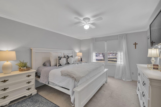 carpeted bedroom featuring ceiling fan and crown molding