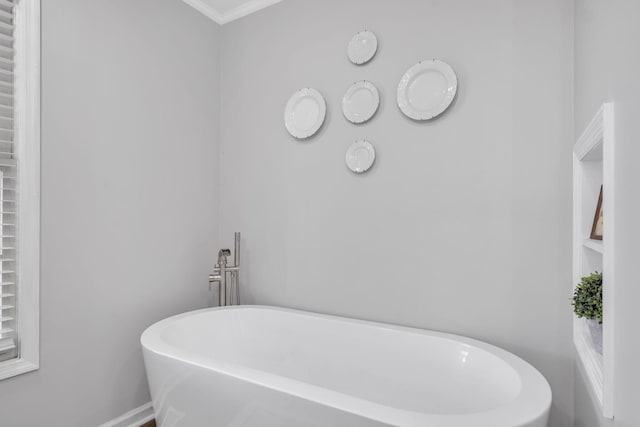 bathroom featuring a bathing tub and crown molding