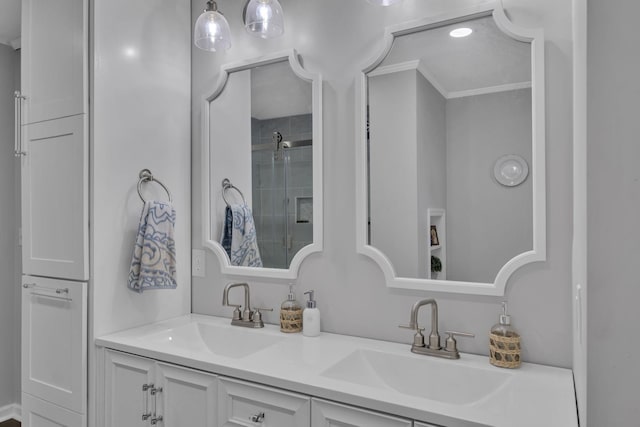 bathroom with crown molding, a shower with door, and vanity