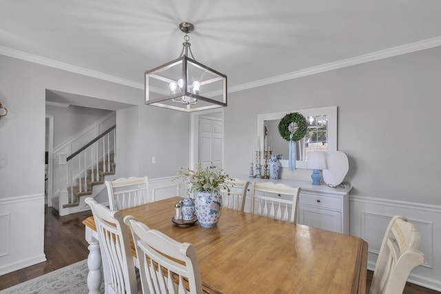 dining area with a chandelier, crown molding, and dark hardwood / wood-style flooring