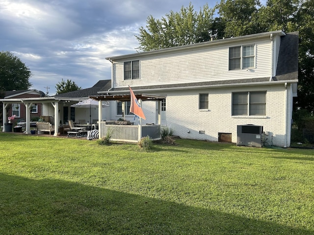 back of property featuring a lawn, central AC unit, a pergola, and a patio