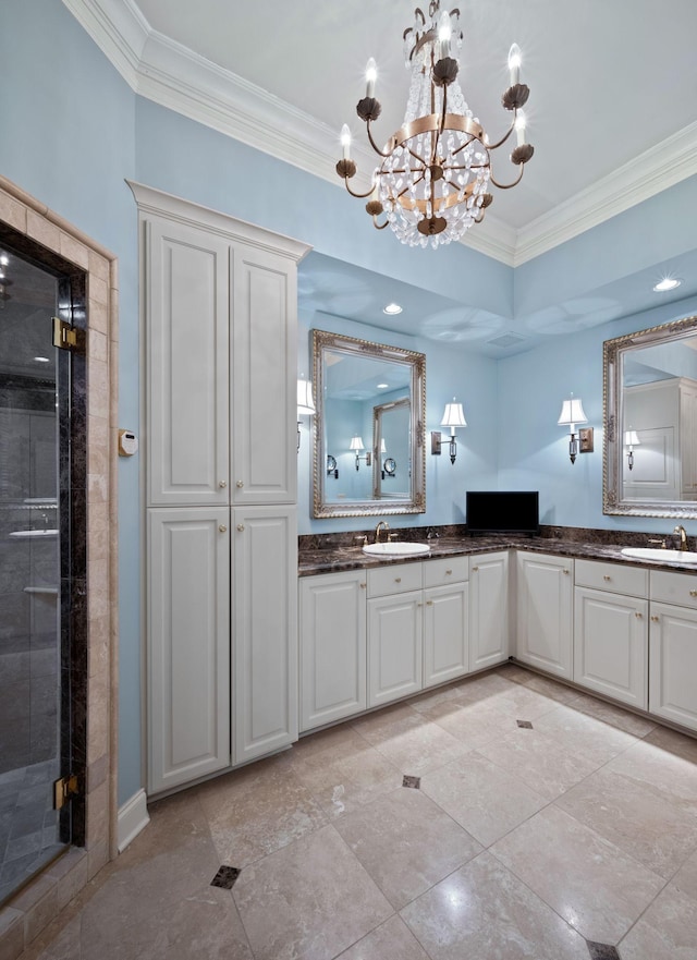 bathroom with a shower with shower door, vanity, a chandelier, and ornamental molding