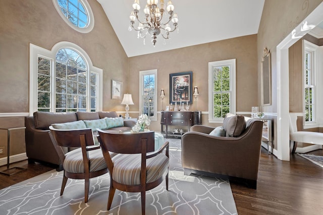 living room featuring high vaulted ceiling, dark hardwood / wood-style flooring, and a chandelier