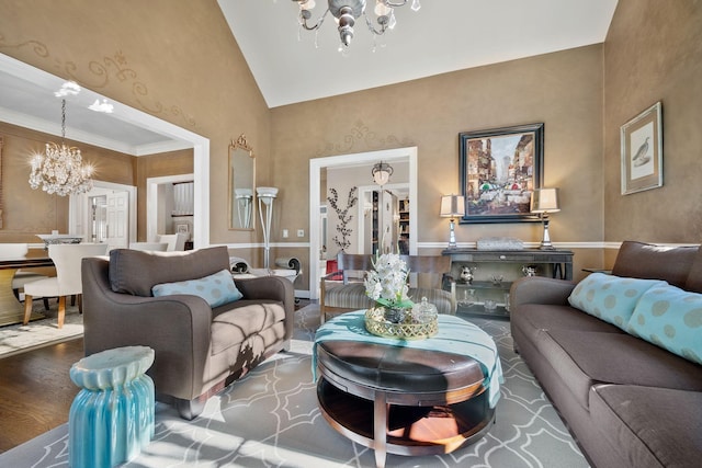 living room featuring lofted ceiling, wood-type flooring, crown molding, and an inviting chandelier