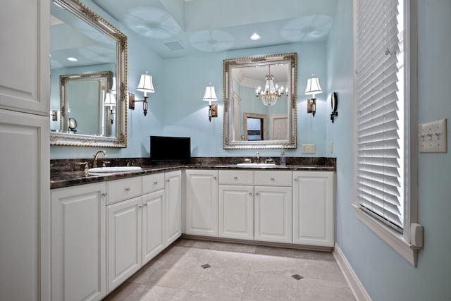 bathroom featuring an inviting chandelier, crown molding, and vanity