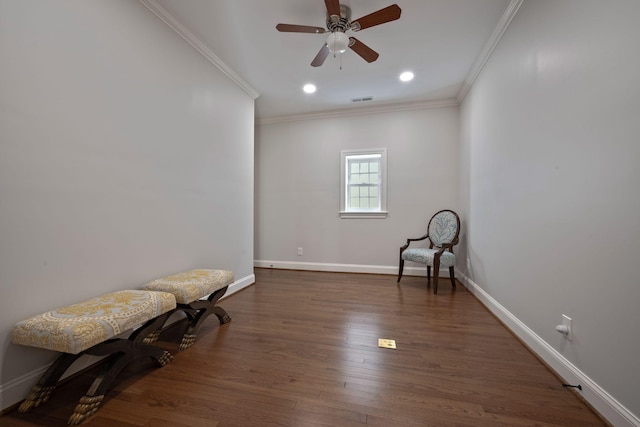 living area featuring ceiling fan, dark wood-type flooring, and ornamental molding