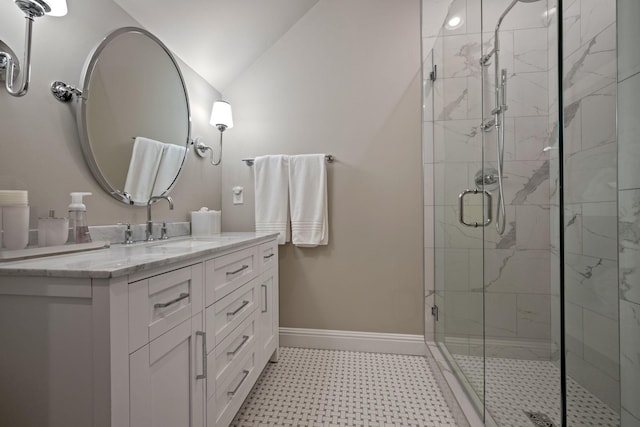 bathroom with lofted ceiling, vanity, and a shower with door