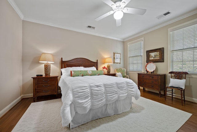 bedroom featuring ceiling fan, dark wood-type flooring, and crown molding