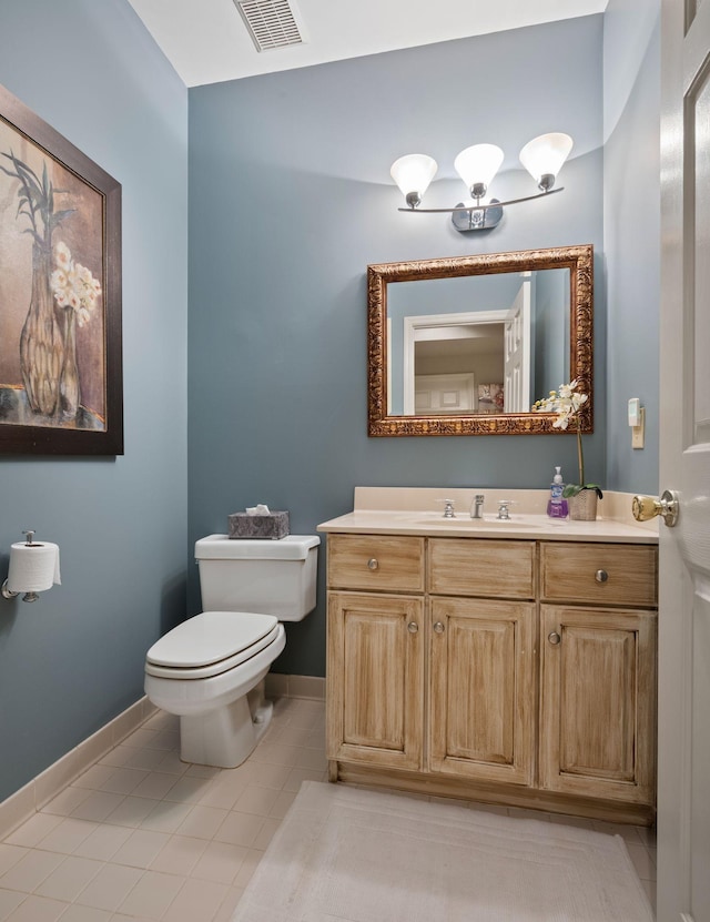 bathroom with toilet, tile patterned flooring, and vanity