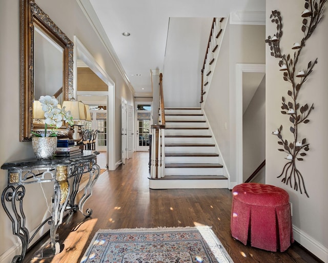 foyer featuring dark hardwood / wood-style flooring and ornamental molding