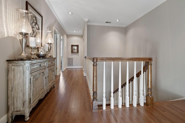 hall with ornamental molding and hardwood / wood-style flooring