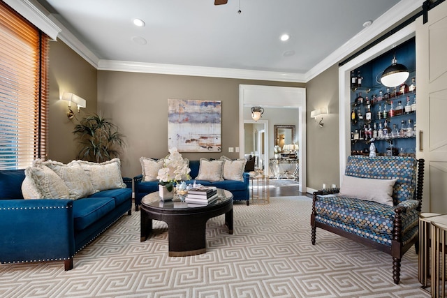 carpeted living room featuring ceiling fan, ornamental molding, and a barn door