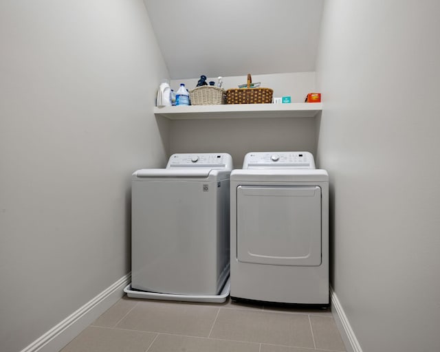 clothes washing area with light tile patterned floors and washing machine and clothes dryer