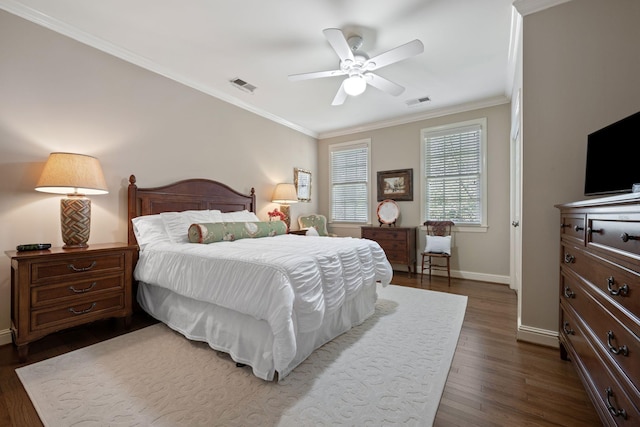 bedroom with ceiling fan, dark hardwood / wood-style floors, and crown molding