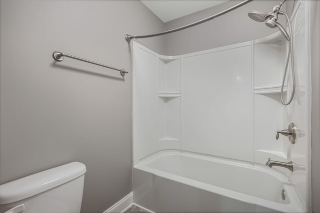 bathroom featuring toilet and  shower combination