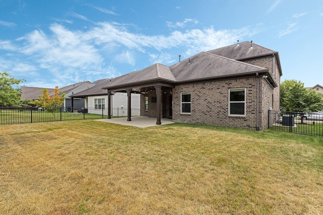 rear view of property with cooling unit, a yard, and a patio