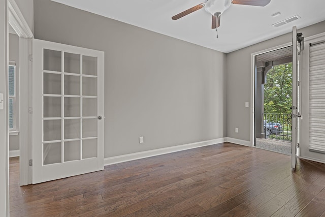 spare room featuring ceiling fan and dark wood-type flooring