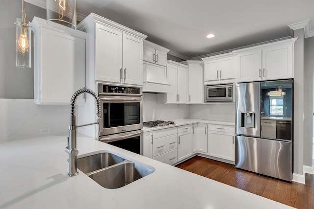 kitchen featuring custom exhaust hood, white cabinetry, stainless steel appliances, hanging light fixtures, and dark hardwood / wood-style floors