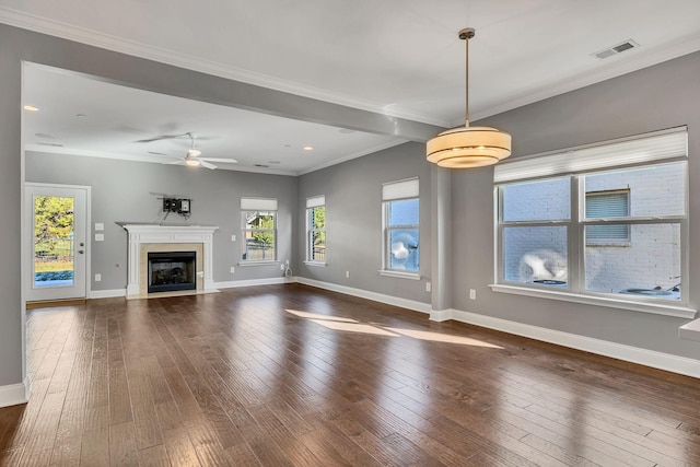 unfurnished living room with ceiling fan, dark wood-type flooring, and crown molding