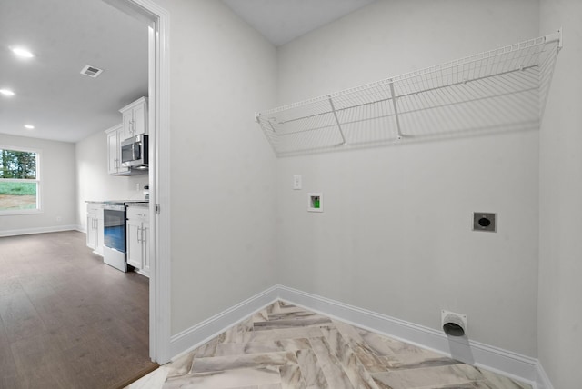 washroom with parquet flooring, washer hookup, and electric dryer hookup