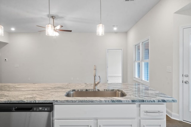 kitchen with white cabinetry, ceiling fan, sink, light stone counters, and stainless steel dishwasher