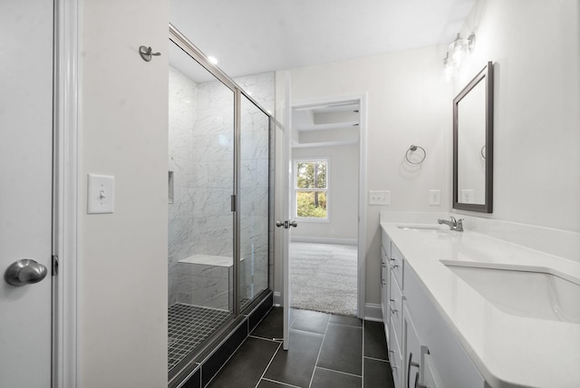 bathroom with a shower with shower door, tile patterned floors, and vanity