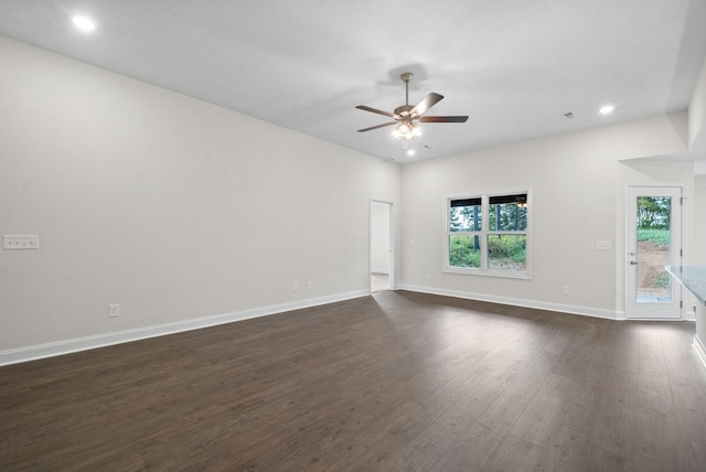 spare room with ceiling fan and dark wood-type flooring