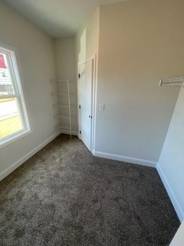 unfurnished bedroom featuring dark colored carpet