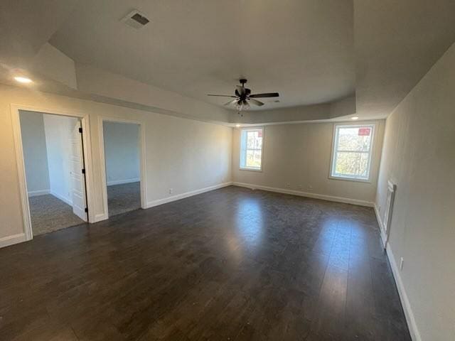 unfurnished room with ceiling fan and dark hardwood / wood-style flooring