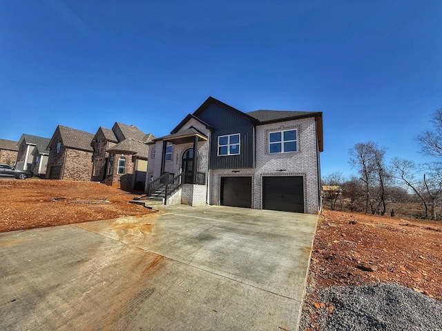 view of front of home featuring brick siding, board and batten siding, concrete driveway, and a garage