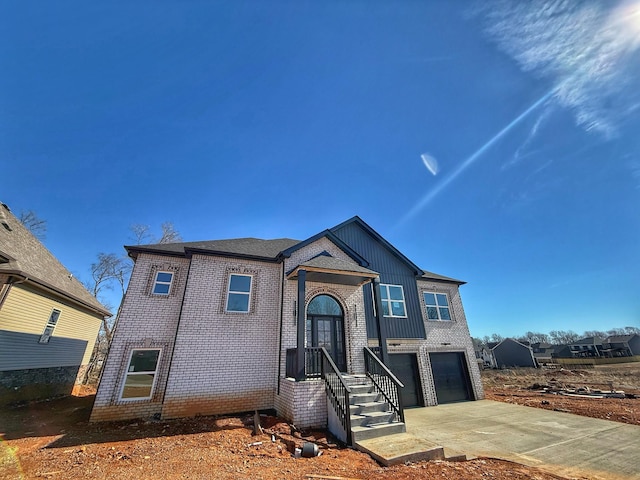 view of front of home featuring concrete driveway, an attached garage, and brick siding