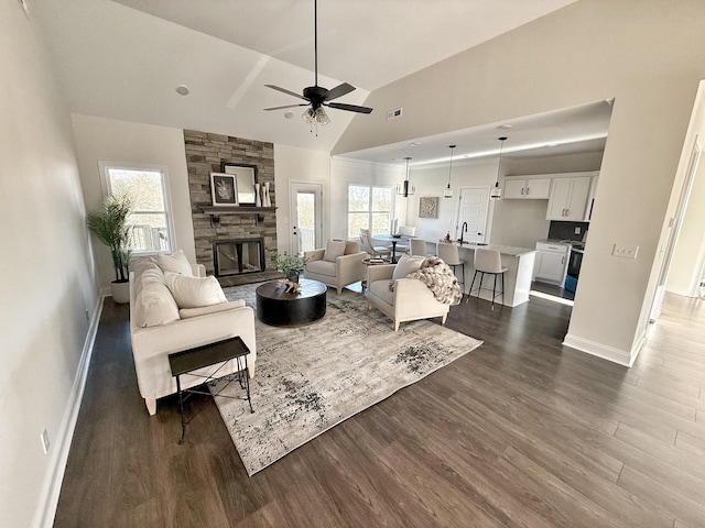 308 Griffey Ests, Clarksville, TN 37042 - living area featuring high vaulted ceiling, a stone fireplace, ceiling fan, dark wood finished floors, and baseboards