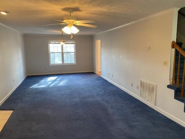 empty room with ceiling fan, ornamental molding, and dark colored carpet