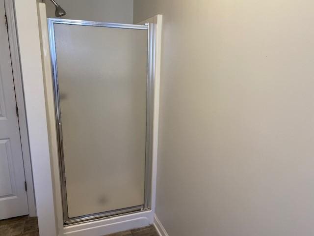 bathroom with a shower with door