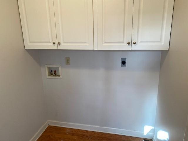 clothes washing area with cabinets, washer hookup, dark hardwood / wood-style floors, and hookup for an electric dryer