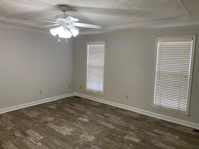 empty room with ceiling fan, a healthy amount of sunlight, dark wood-type flooring, a textured ceiling, and ornamental molding