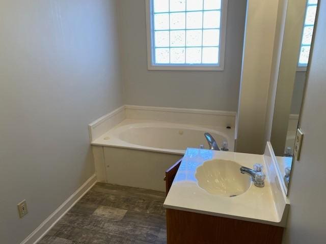 bathroom with a tub to relax in and vanity