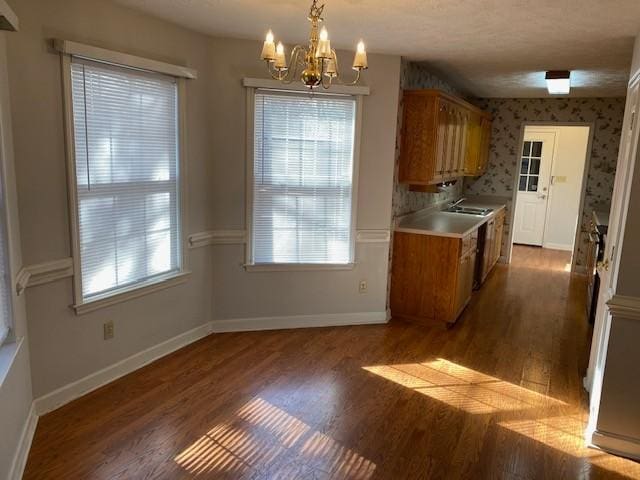 kitchen featuring a chandelier, dark hardwood / wood-style floors, hanging light fixtures, and sink