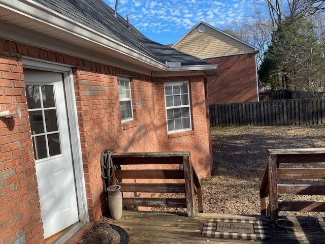 view of side of home with a wooden deck