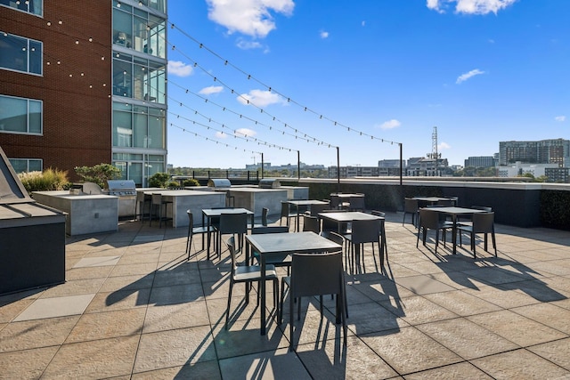 view of patio with area for grilling and an outdoor bar