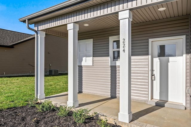 property entrance with covered porch and central air condition unit