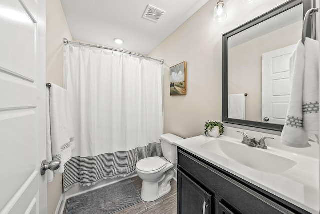 bathroom with toilet, vanity, and a shower with curtain