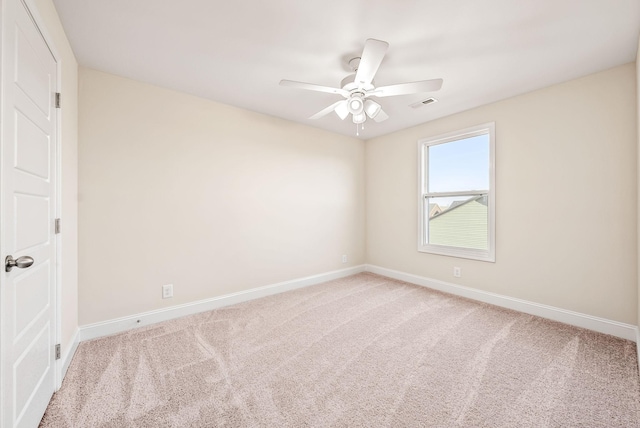 spare room featuring light carpet and ceiling fan