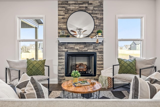 living room featuring ceiling fan, a fireplace, and hardwood / wood-style floors