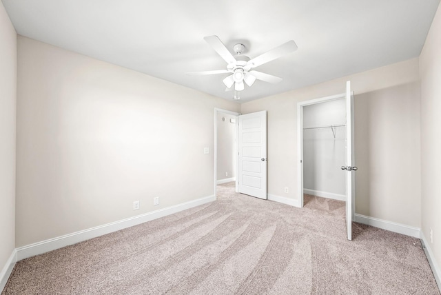 unfurnished bedroom with ceiling fan, light carpet, and a closet