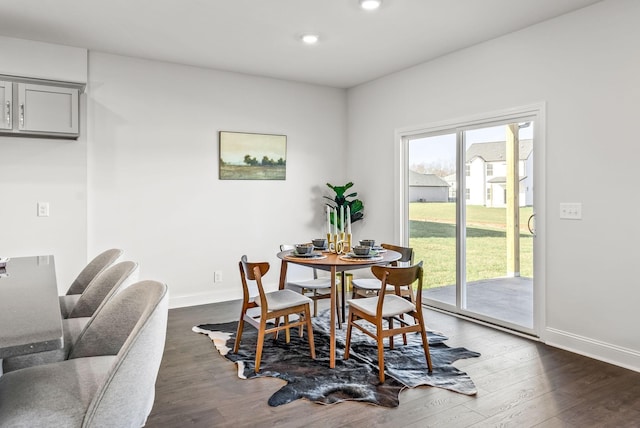 dining space with dark hardwood / wood-style floors