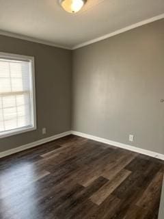 empty room with dark wood-type flooring and ornamental molding